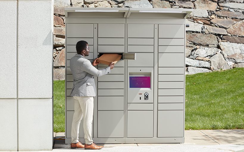 Man using outdoor smart parcel lockers to pick up a package