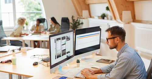 Man researching accounting software at office