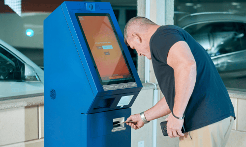 Man using blue self-service banking machine  copy