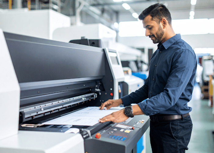 Pakistani man using industrial printer copy