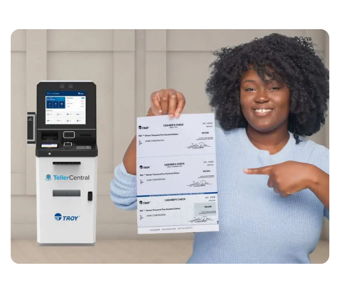 Woman holding checks in front of self-service banking machine
