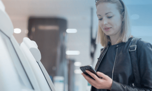 Woman on phone using a  self-service machine  copy