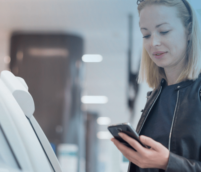Woman on phone using a self-service machine  copy