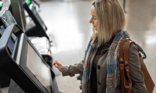Woman using self service machine at a bank copy