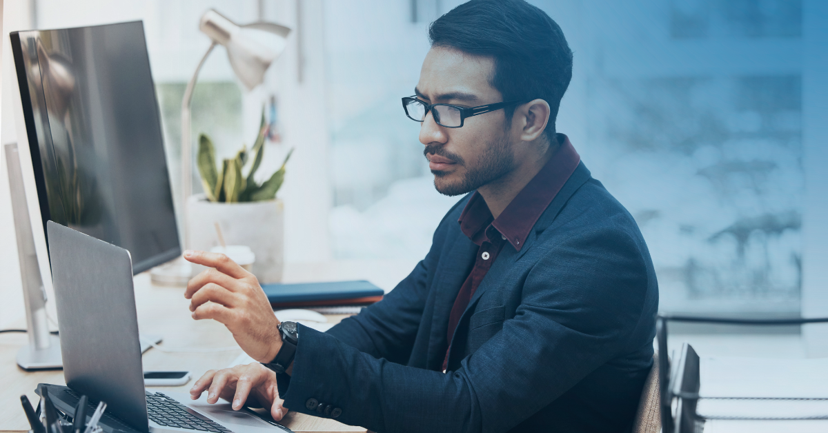 Man in his office using check printing software