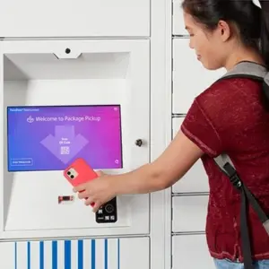 Student using smart parcel locker with phone Student using smart parcel locker with phone