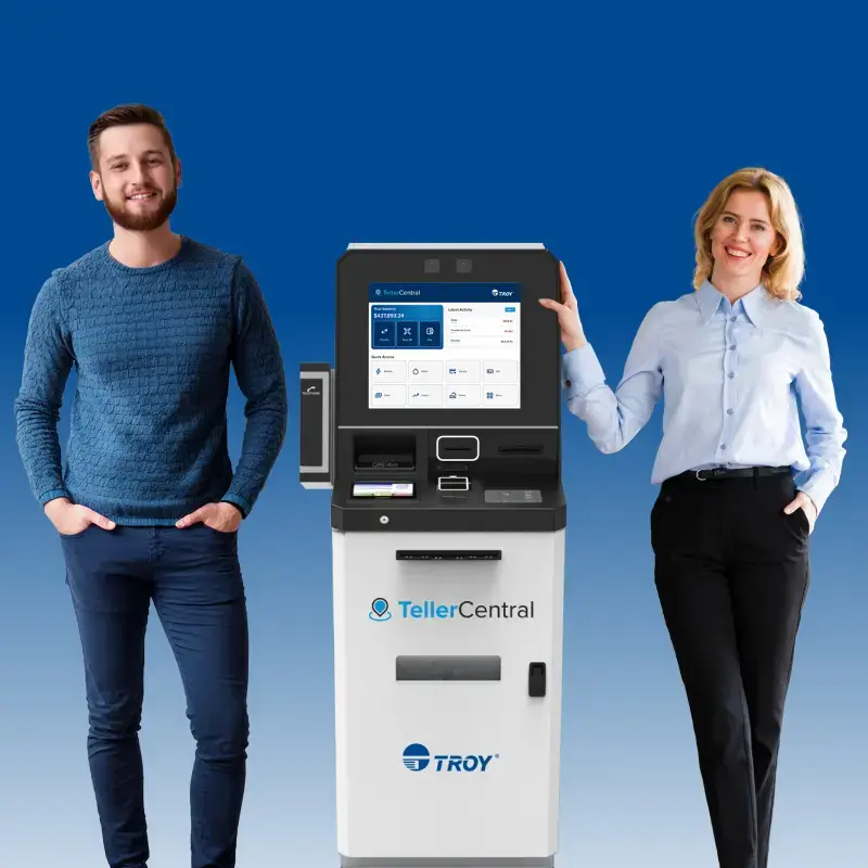 Two people standing in front of a self-service kiosk